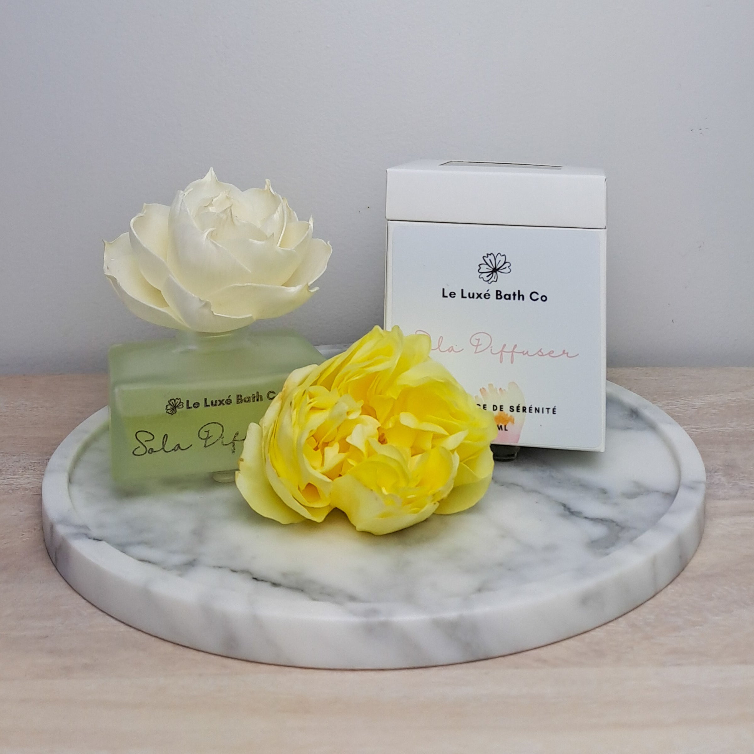 Le Luxé Bath Co Flower Fragrance Diffuser with fresh rose and style packaging on wood and marble surface